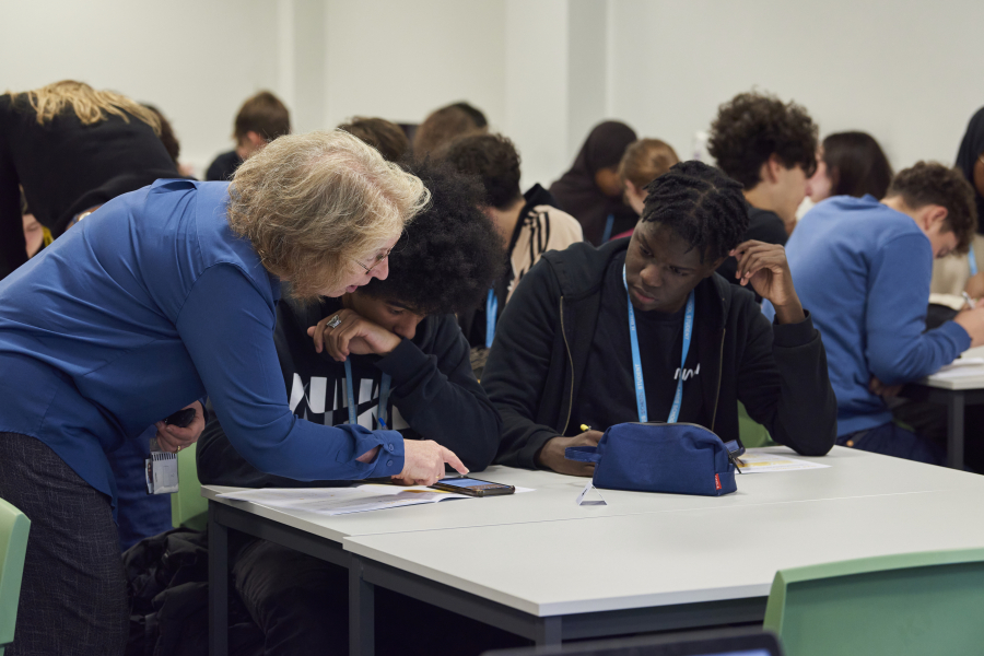teacher and young people in classroom