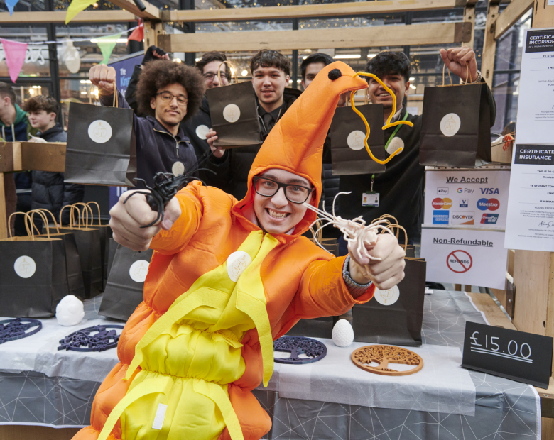 student at trade stand in a costume