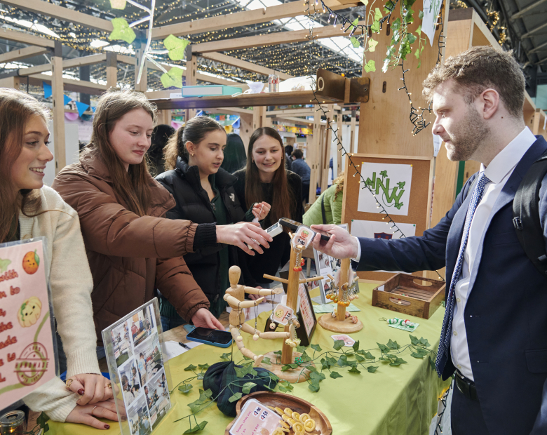 group of students at trade stand with MP