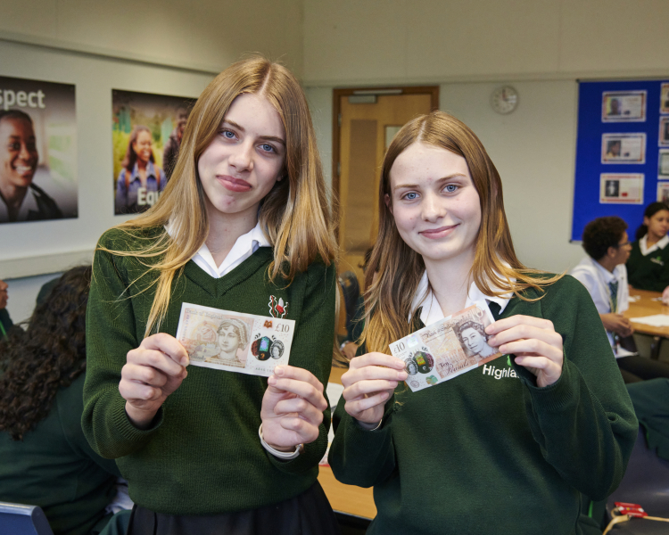 girls hold a £10 note