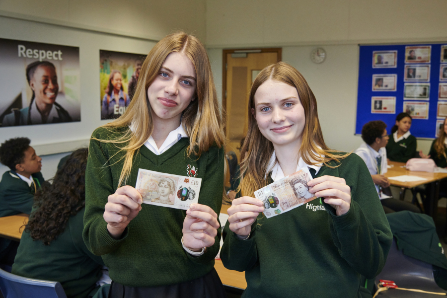 girls hold a £10 note